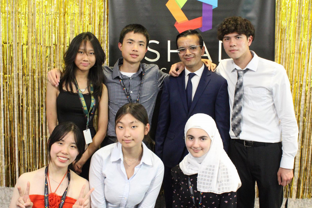 a group of seven students posing for a photo