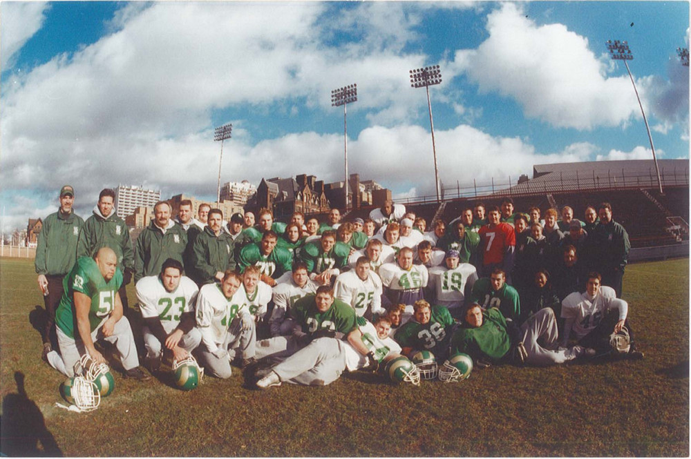 a group of football players pose for a photo