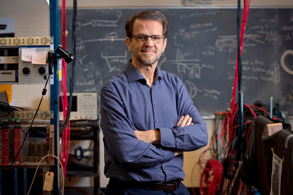 A man stands in the midst of a laboratory.