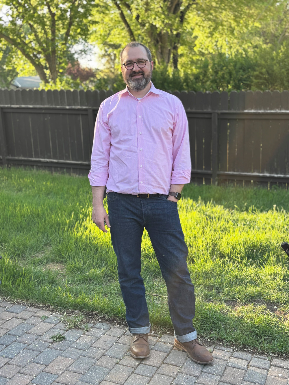 A man stands in a back yard