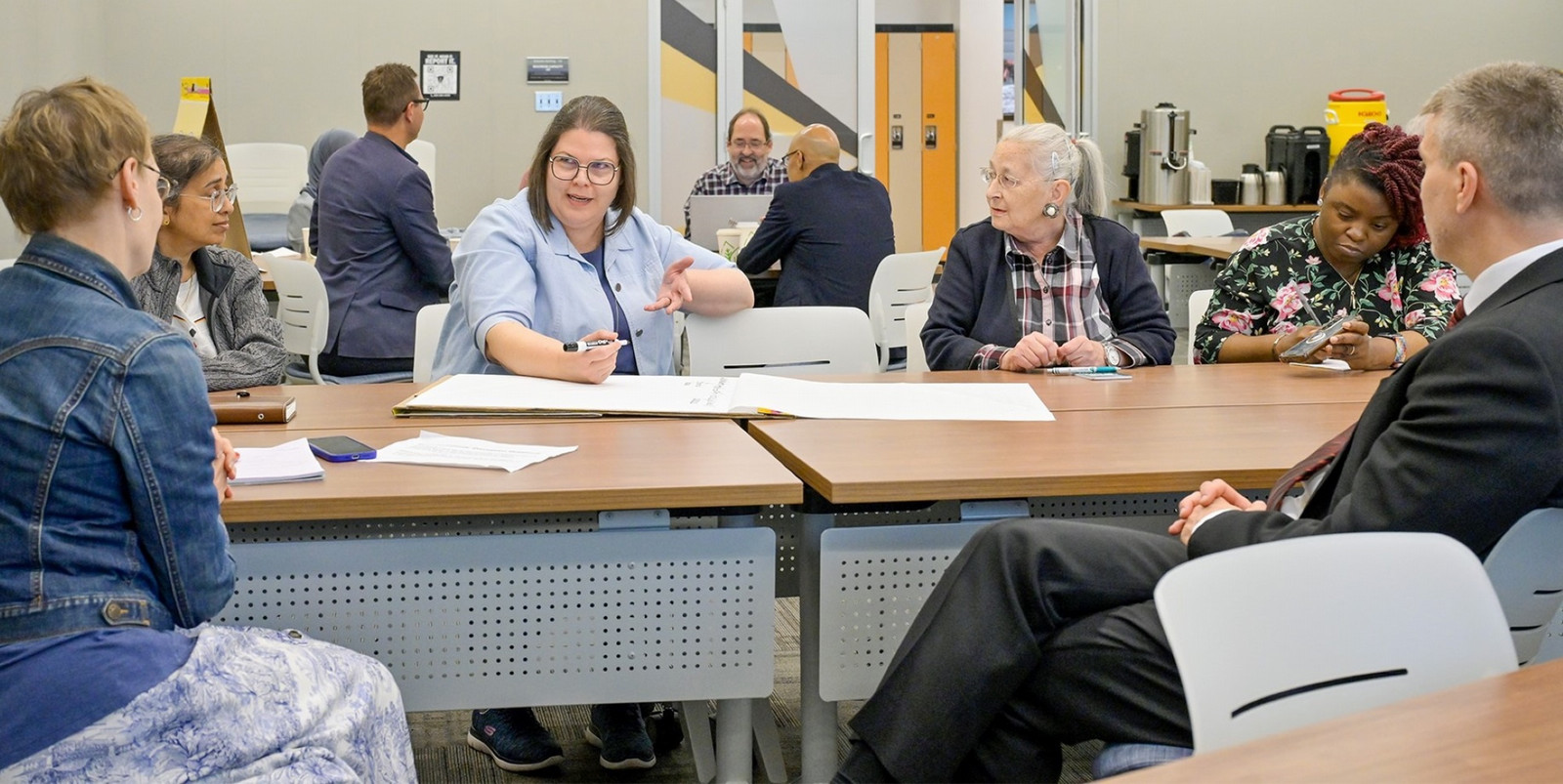 A group of people in a meeting room. 