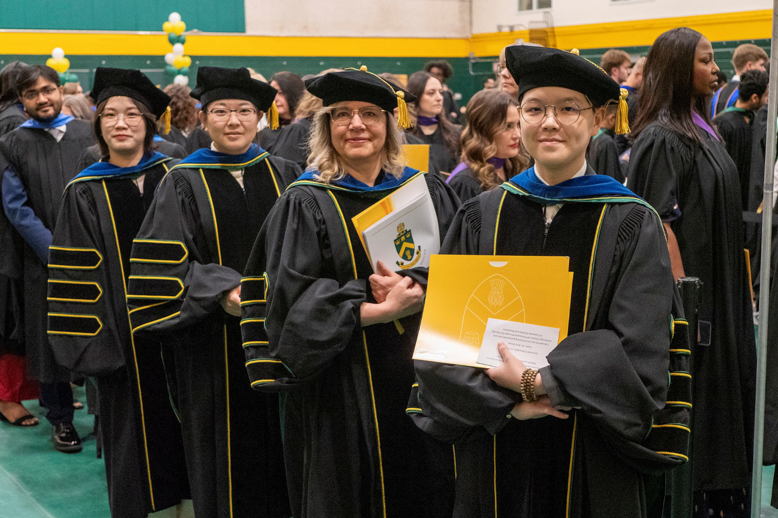 a group of students wearing gowns at convocation