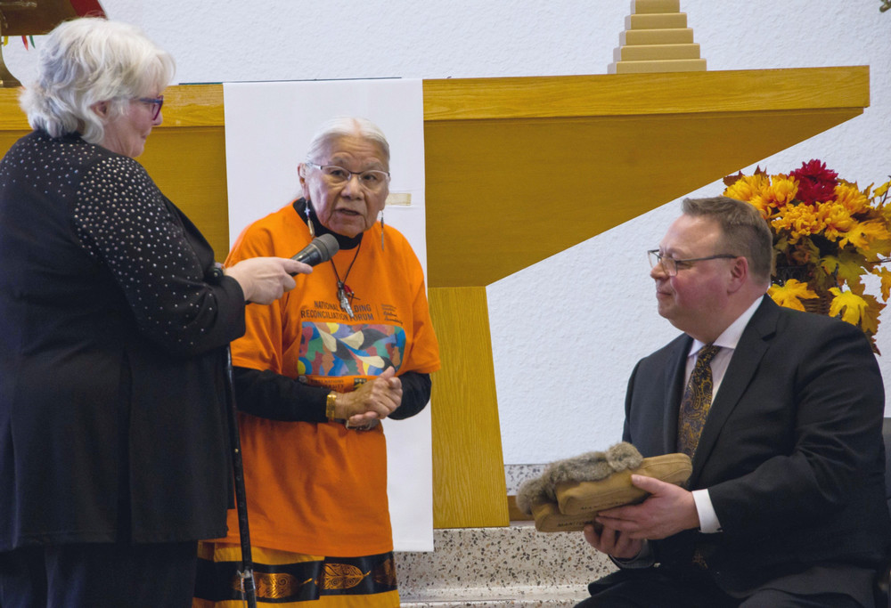 two women and one man on a church altar