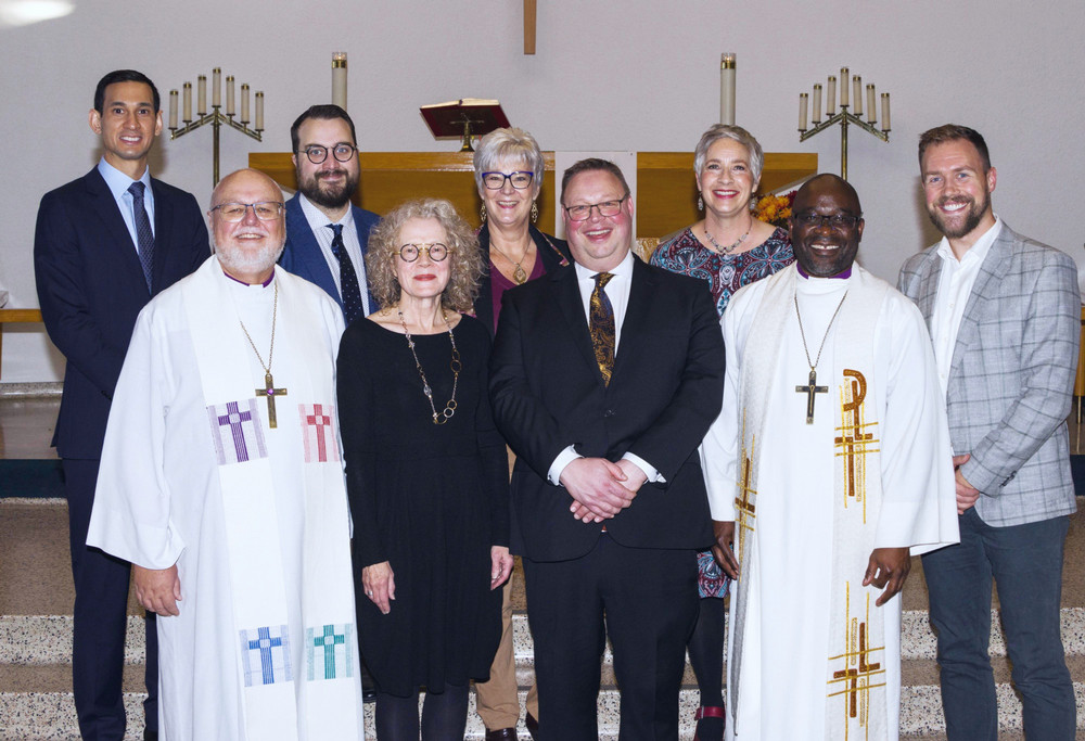 a group of smiling people standing on a church altar