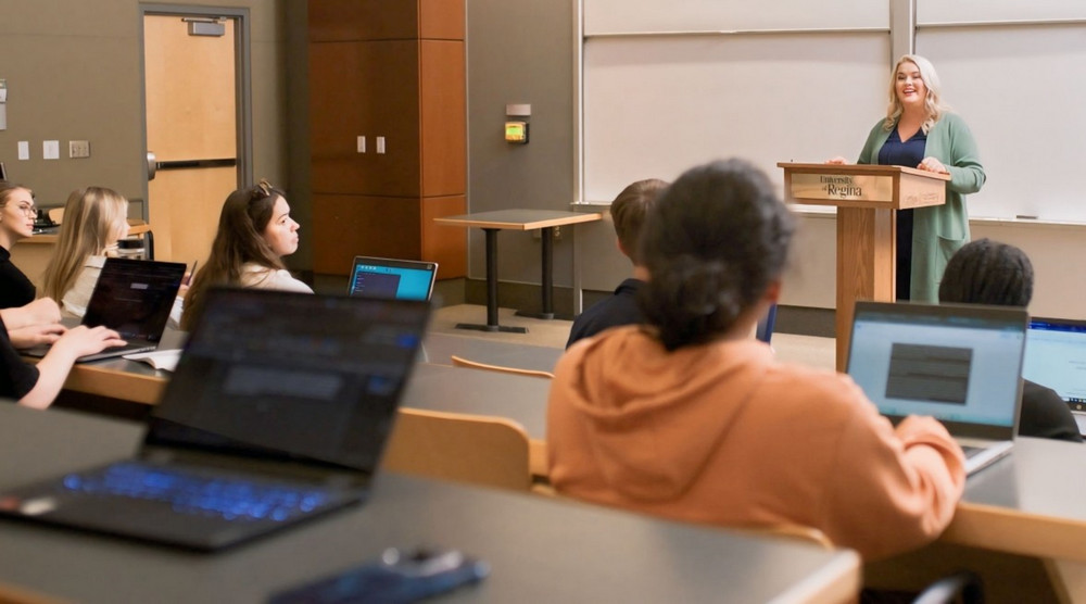 person speaking at a podium while students listen