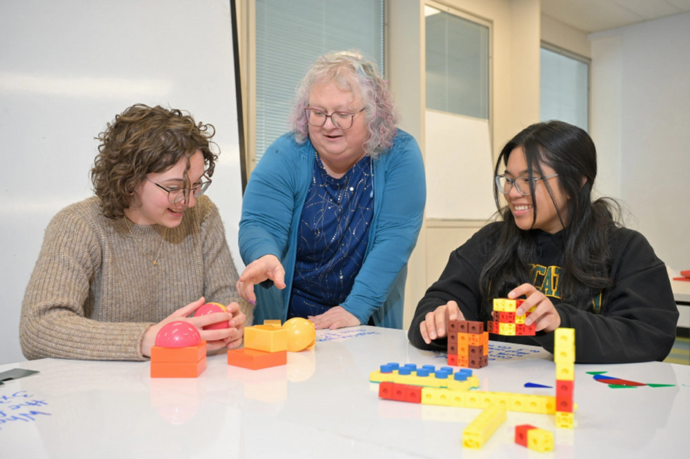 three people sitting at a table