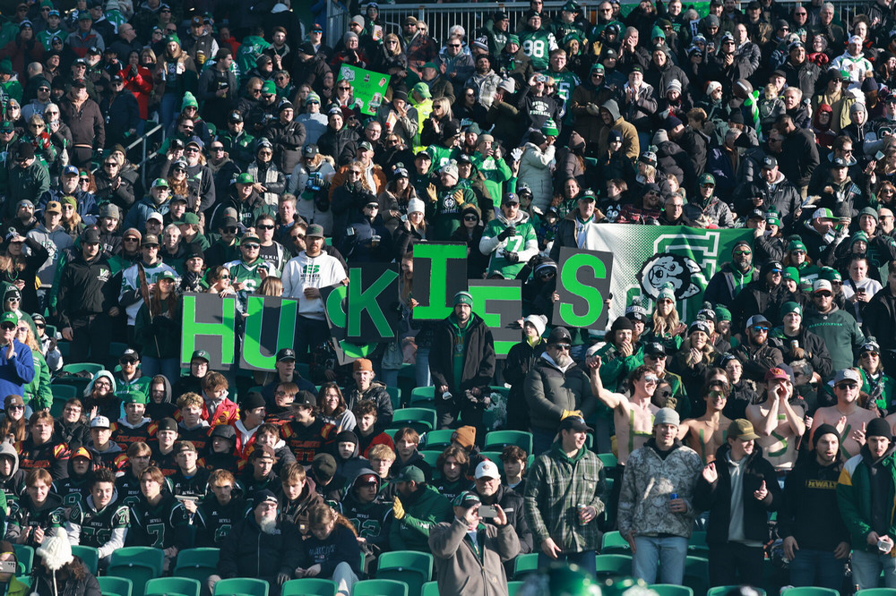 Packed group of football fans in a stadium.