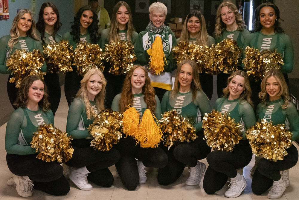 A group of cheerleaders poses for a photo.  