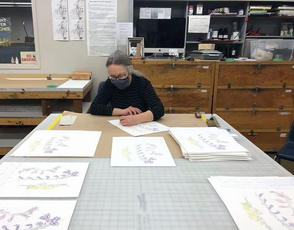 person sitting at a table examining art