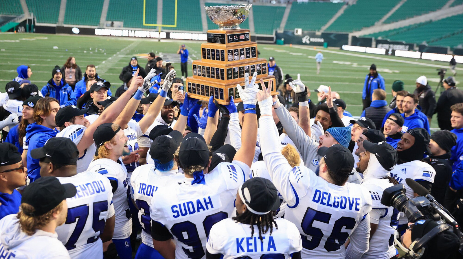 a football team hoists the championship trophy