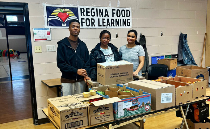 three people standing facing the camera