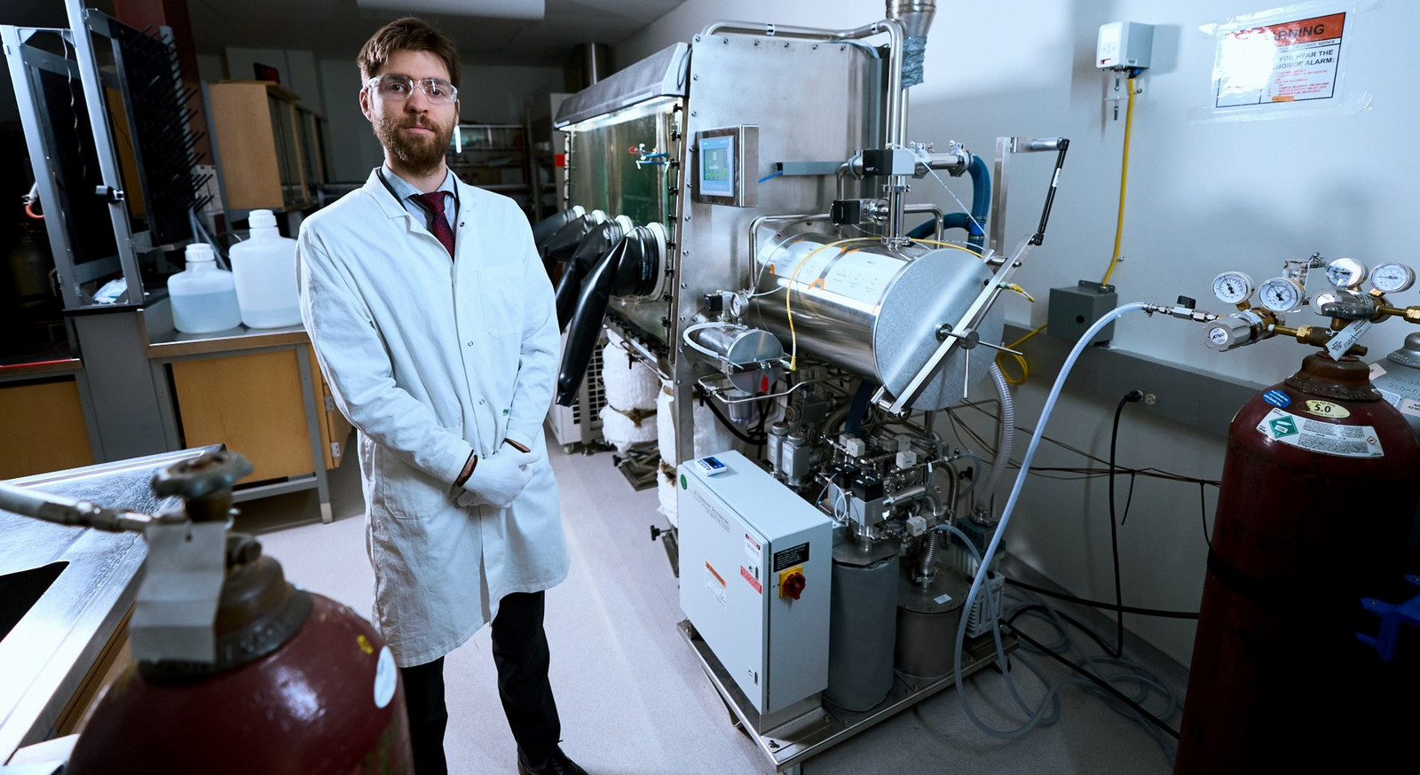 a man in a shite lab coat standing in a laboratory