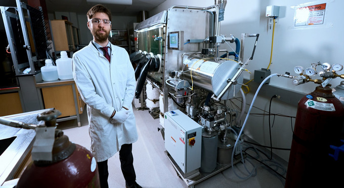 a man in a shite lab coat standing in a laboratory