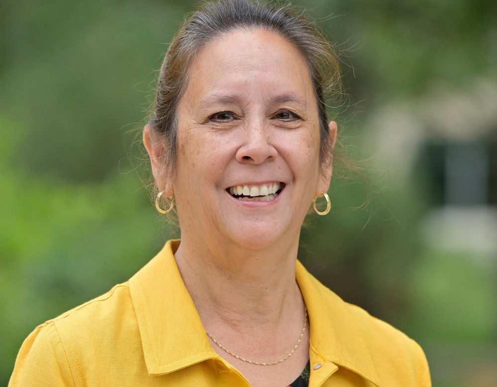 A woman poses smiling