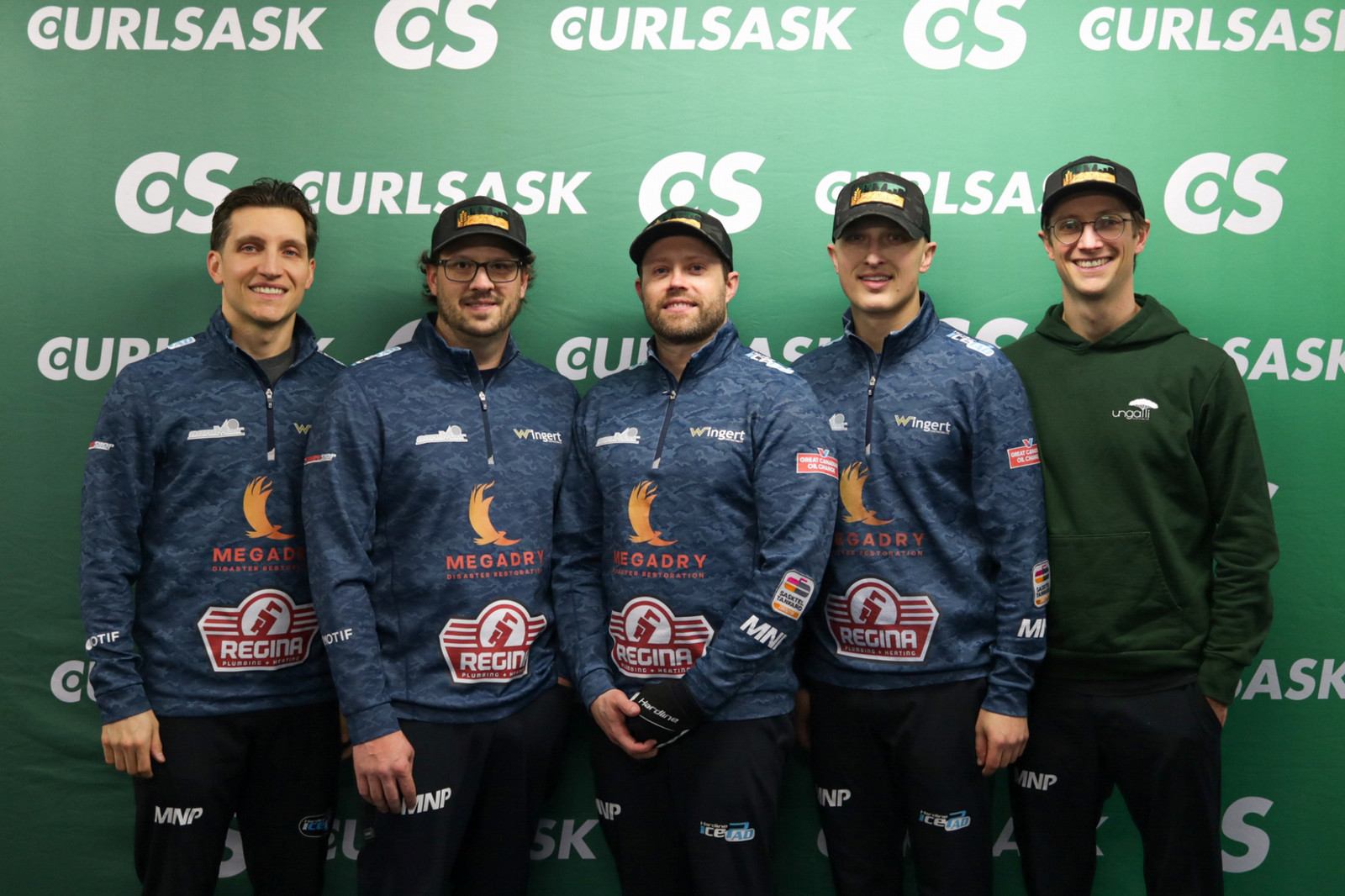 six people standing and smiling at the camera