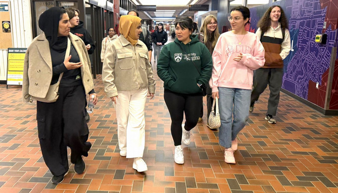Students walking down hallway.