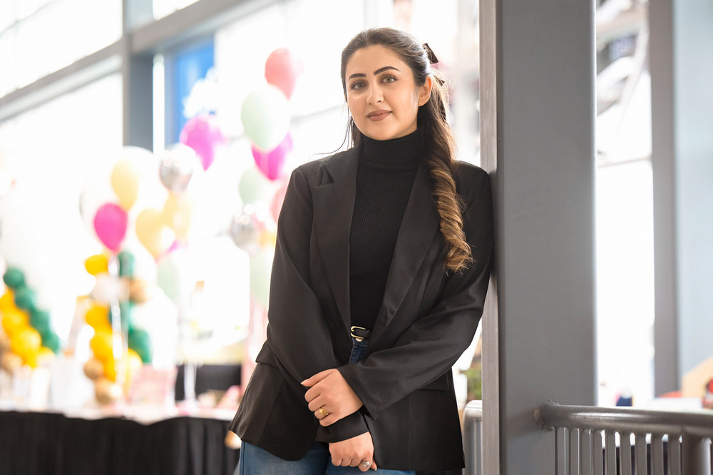 young woman standing indoors