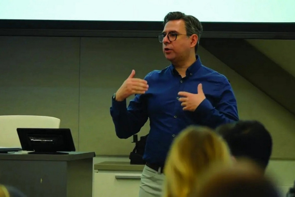 Dr. Soroush Sabbaghan gestures while speaking to an audience in a university lecture hall