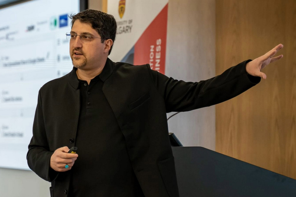 Dr. Mohammad Keyhani gestures while presenting at the University of Calgary's Haskayne School of Business