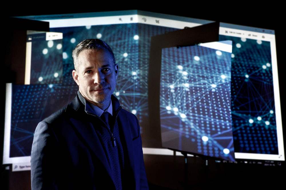 man posing for a photo in a dark room