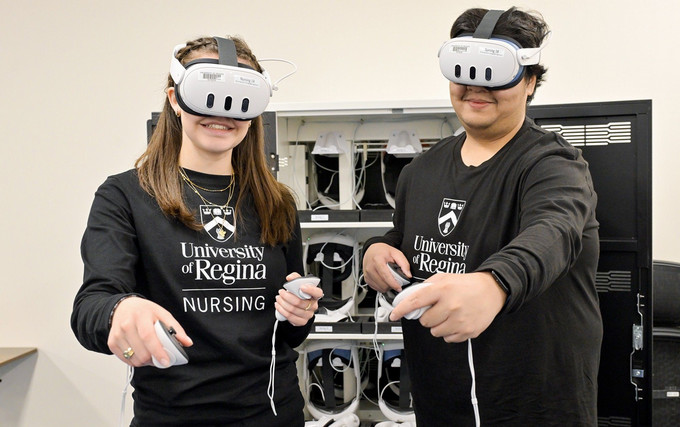 Students with virtual reality headsets on in a lab setting. 