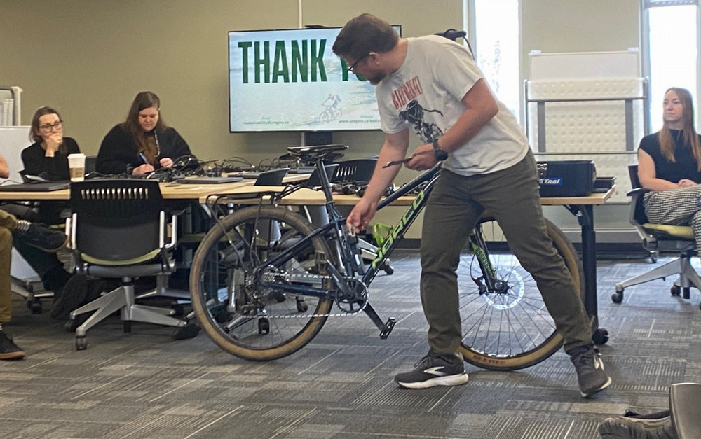 a man demonstrating bike maintenance