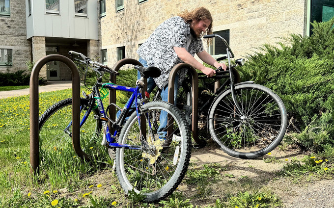 person locking up a bike