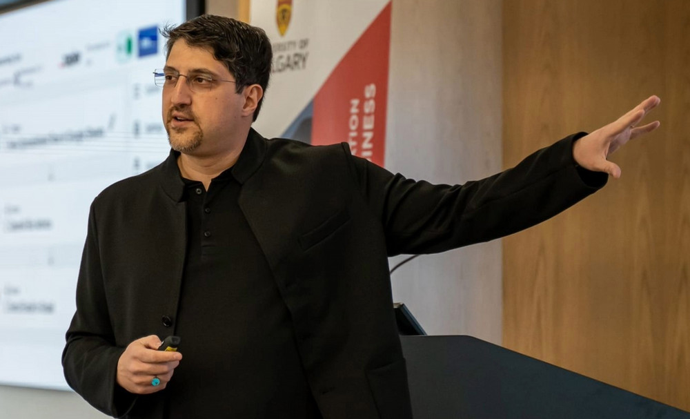 man presenting in a professional academic setting