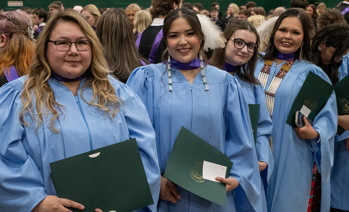 three smiling graduates
