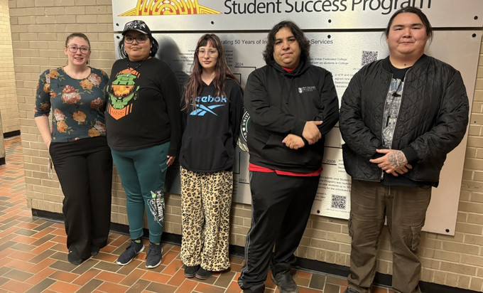 A group of individuals standing side-by-side in a hallway.