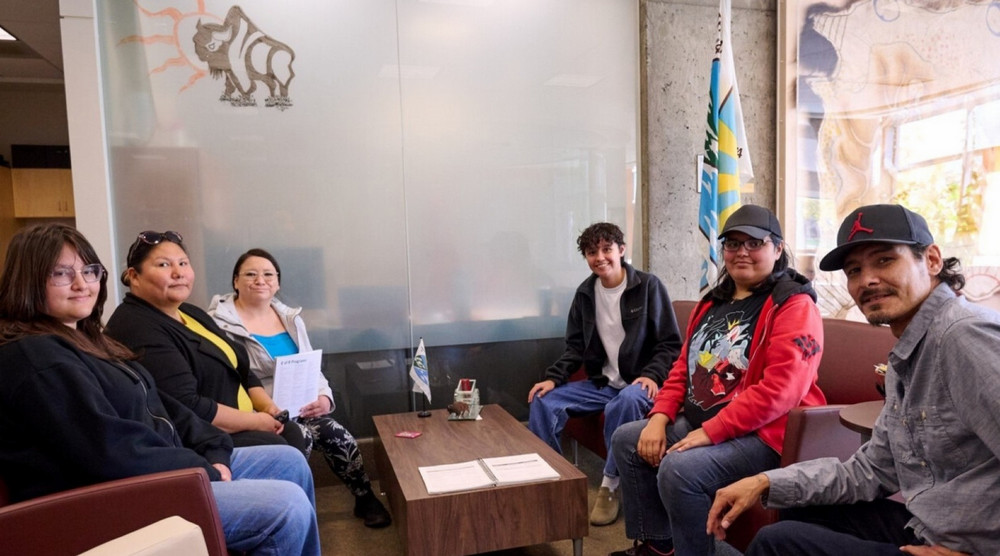 A group of individuals sitting around a coffee table