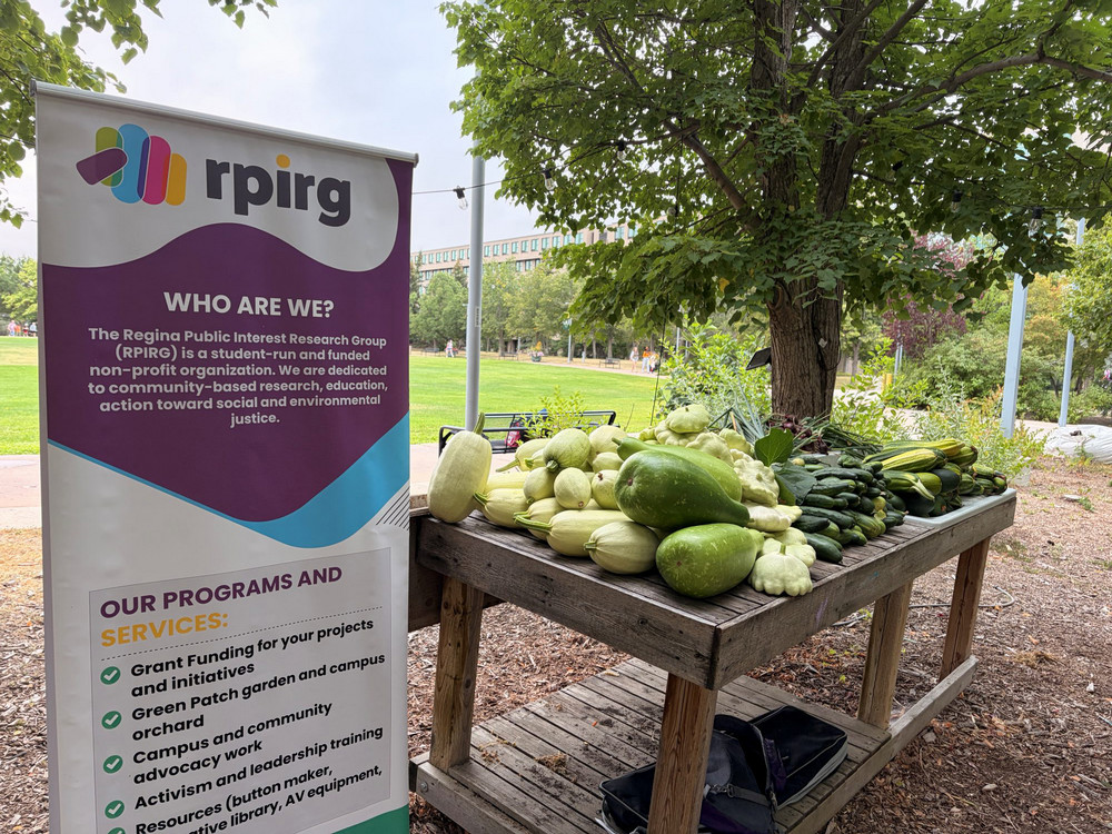 Table with vegetables beside a banner