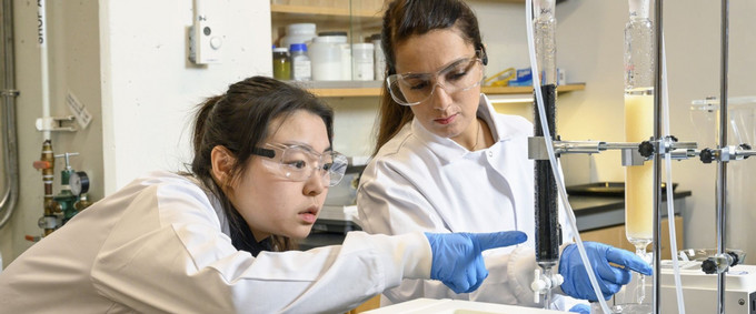 two scientists in white coats in a laboratory