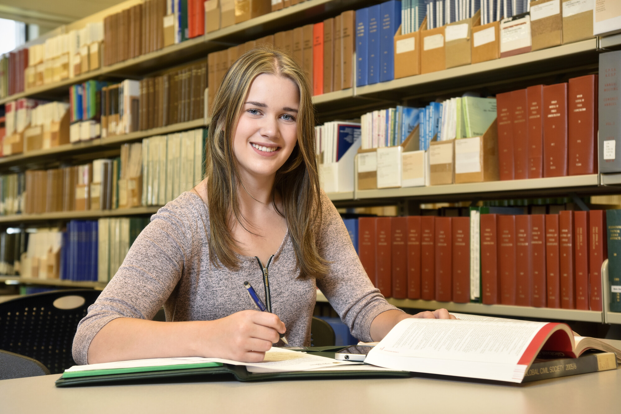 smiling student with textbooks