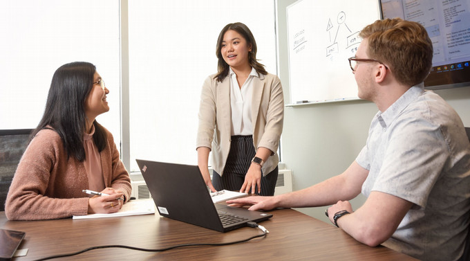 three students sitting at a table