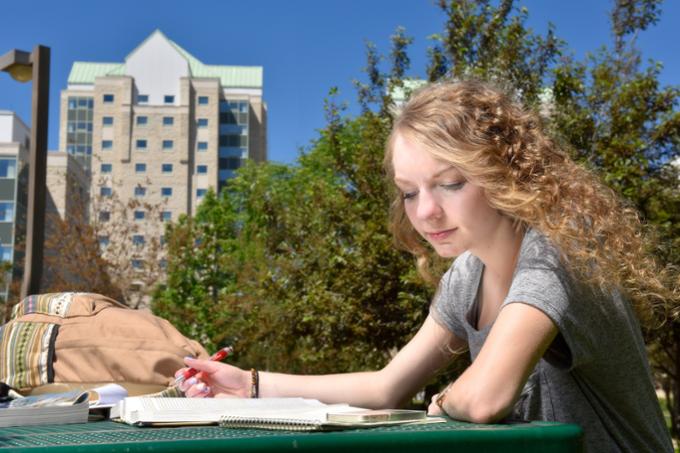 Student studying outside on campus