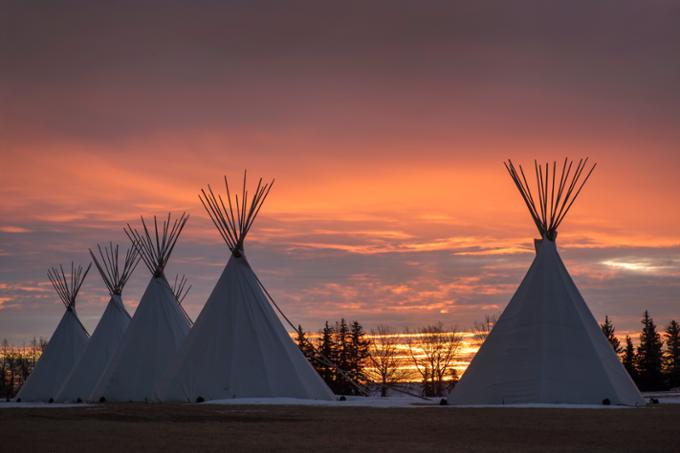 Tipis with a sunset