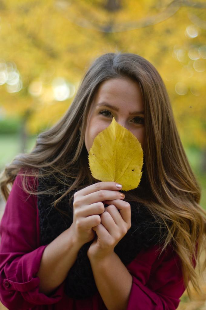 Female student holding a leaf