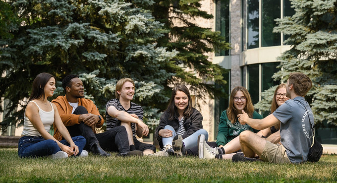 Seven people sitting and smiling