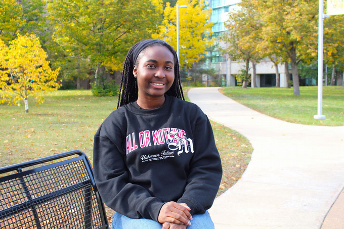 Girl sitting on a bench.