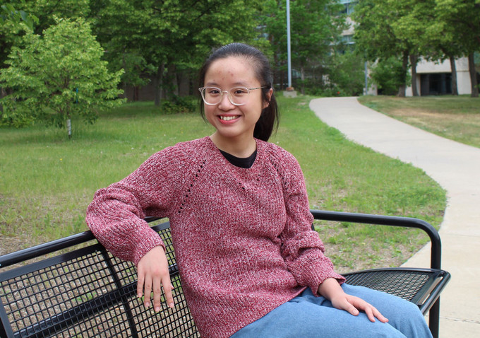 Girl standing with backpack.