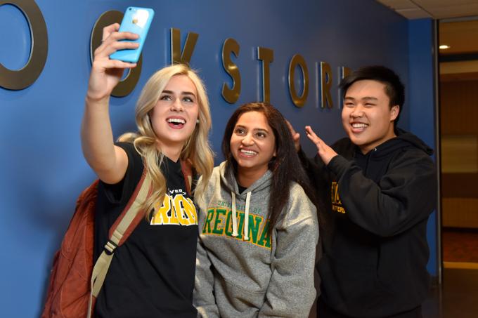 Three students taking a photo together