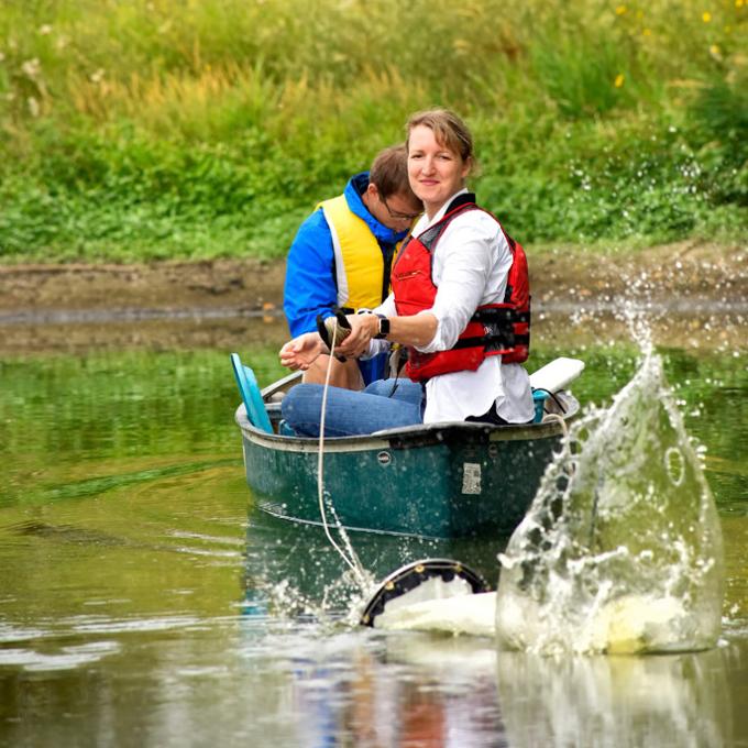 two people in boat fishing